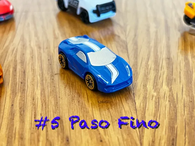 A carousel photo displaying the fifth vehicle named 'Paso Fino' out of an array of 'Standard cars', at full size. The car is painted ocean blue with a rectangular white symbol printed.