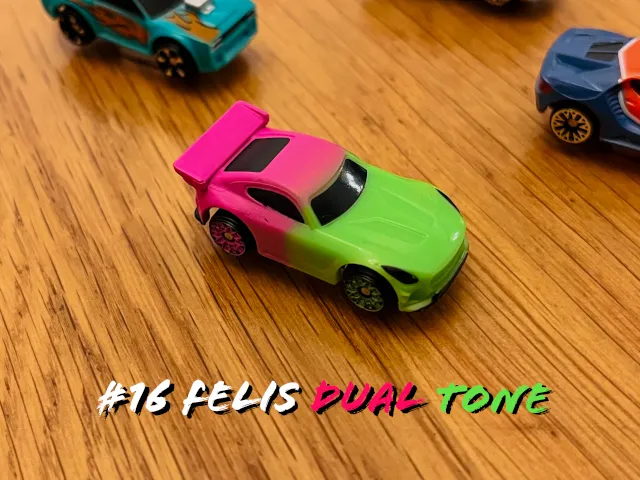 A carousel photo displaying the sixteenth vehicle named 'Felis Dual Tone' out of an array of 'Deluxe Cars', at full size. The car is painted forest-green with a pink backdrop trunk.