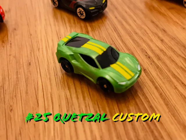 A carousel photo displaying the twenty-fifth vehicle named 'Quetzal Custom' out of an array of 'Deluxe Cars', at full size. The car is painted mostly lime-green with double strikes of yellow across the middle.