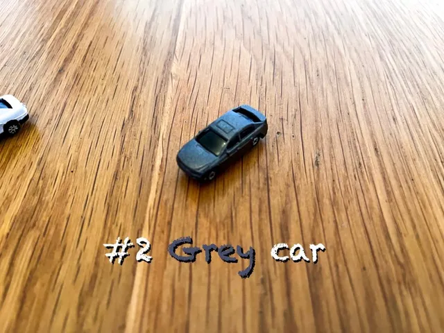 A carousel photo displaying the second car named 'Grey car' out of an array of V.I.A. 'mini Standard cars', at mini size. The car is painted grey with a standard SUV design.