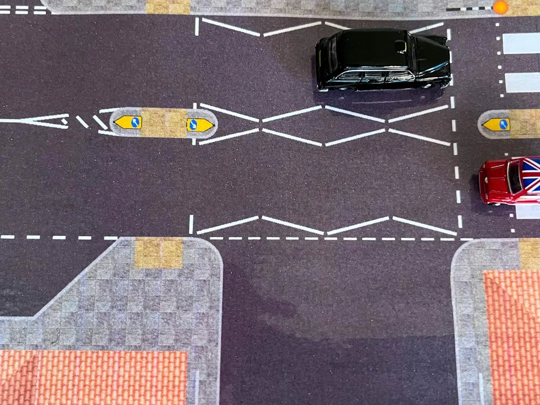 A close-up shot of a magnetic car waiting close proximity at a detailed and accurately designed pedestrian zebra crossing.