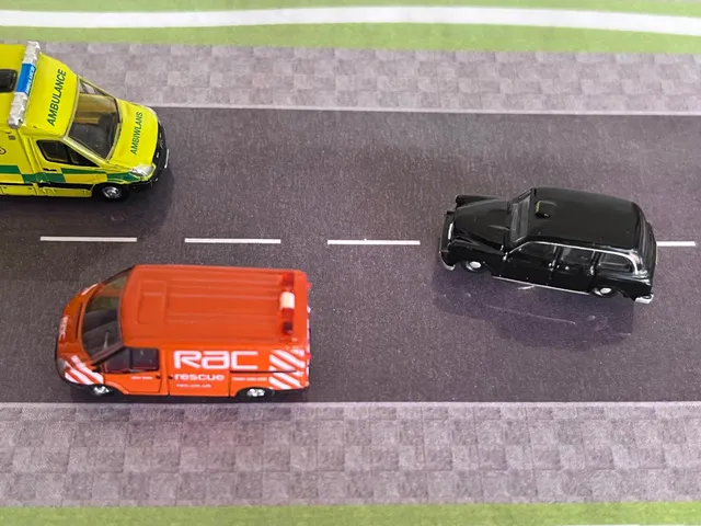 Showing meeting and priority by positioning a ambulance proximity of the parked red van.