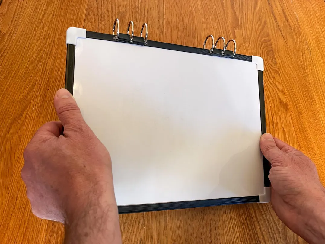 Tenth 'Compact & Convenient' carousel image having Julian tilt the V.I.A. kit's whiteboard on a 45∠ degrees angle.