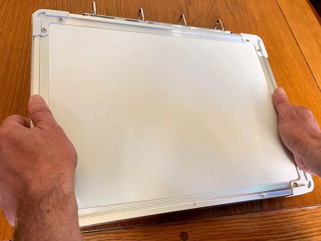 Sixth 'Compact & Convenient' carousel image showing off Julian holding the V.I.A. kit's whiteboard on it's back.